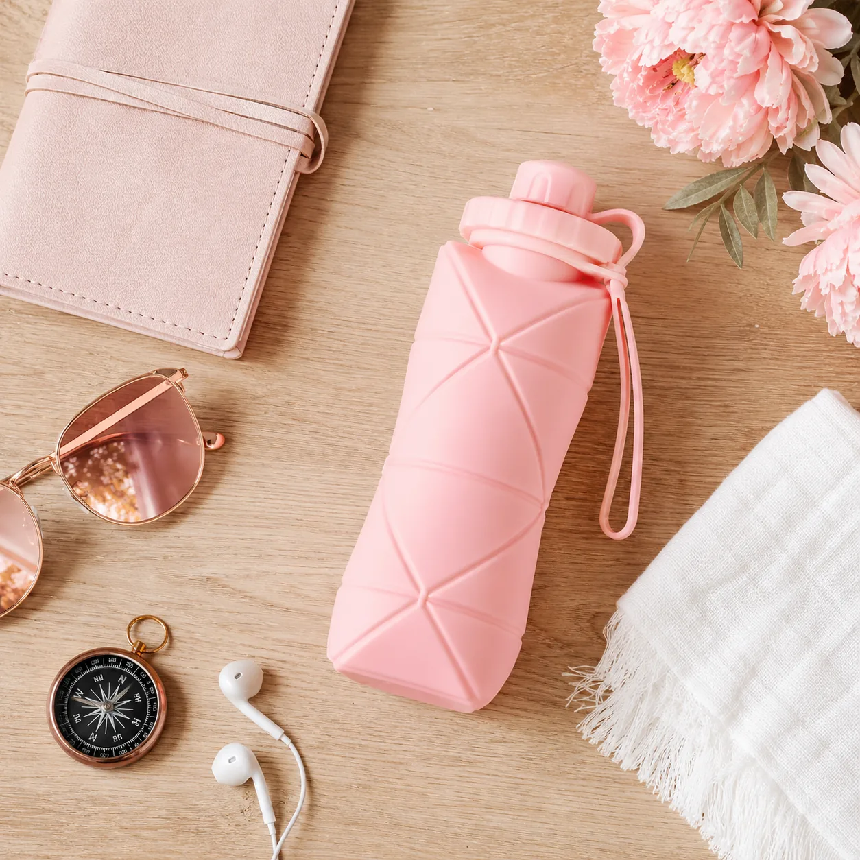 Pink collapsible silicone water bottle that folds flat for travel - View 4