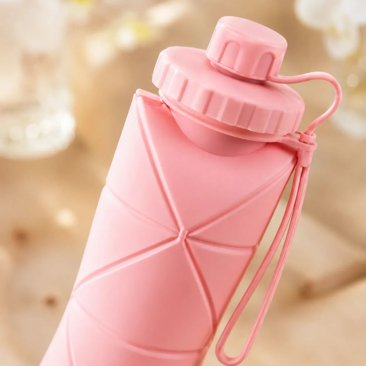 Pink collapsible silicone water bottle that folds flat for travel - View 5